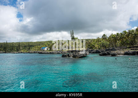 TADINE,MARE,NEW CALEDONIA-DECEMBER 3,2016: Stunning azure lagoon on the Pacific Ocean coast with natural rock and rainforest in Tadine, New Caledonia Stock Photo