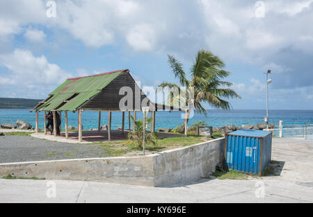 TADINE,MARE,NEW CALEDONIA-DECEMBER 3,2016: People talking under worn shelter in Tadine, Mare, New Caledonia Stock Photo