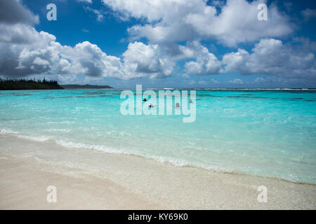 TADINE,MARE,NEW CALEDONIA-DECEMBER 3,2016: Tourists swimming in the Pacific Ocean waters on excursion at Yejele Beach in Mare, New Caledonia Stock Photo