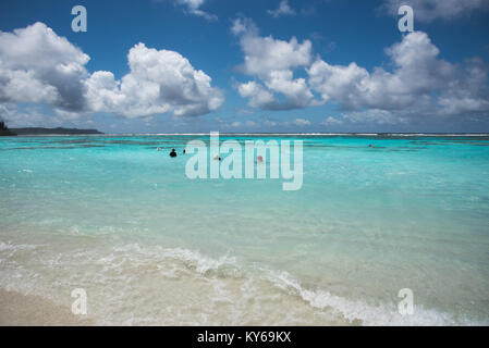 TADINE,MARE,NEW CALEDONIA-DECEMBER 3,2016: Tourists swimming in the Pacific Ocean waters on excursion at Yejele Beach in Mare, New Caledonia Stock Photo