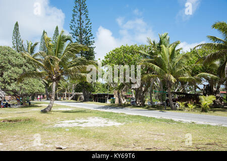 TADINE,MARE,NEW CALEDONIA-DECEMBER 3,2016: Lush tropical flora, tourists and local food vendors at Yejele Beach in Mare, New Caledonia Stock Photo