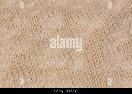 Macro color image of beige knitted texture. Stock Photo