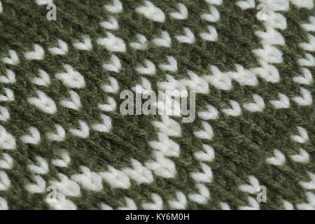 Macro color image of green and white knitted texture.