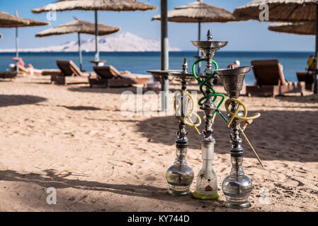Three luxury shisha hookahs on the sandy beach of Red Sea in Sharm El Sheikh, Egypt. Stock Photo