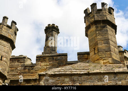 Old stone turrets of the Battle Abbey Gatehouse against the blue summer sky.  Located in Battle, East Sussex, United Kingdom. Stock Photo