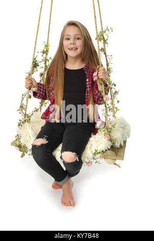 8 year old girl playing on a swing Stock Photo