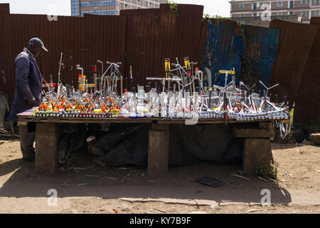 A Kenyan man stands by his roadside stall which has various work tools on display for sale, Nairobi, Kenya, East Africa Stock Photo