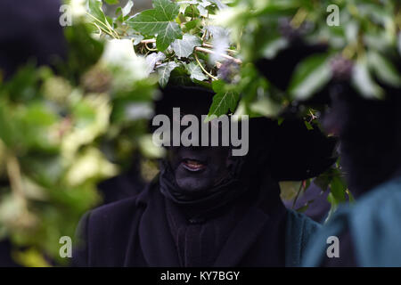 Molly dancers await the start of the 39th Whittlesey Straw Bear Festival in Cambridgeshire. Stock Photo