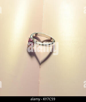 Silver heart shape ring with purple background Stock Photo Alamy