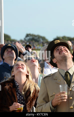 Goodwood Revival visitors in vintage attire looking up at the planes flying in the air show. People in old period costume clothes with eyes to the sky Stock Photo
