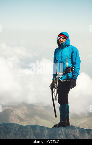 Man climber on mountain glacier Travel Lifestyle concept adventure active vacations outdoor mountaineering sport alpinism equipment ice axe and crampo Stock Photo