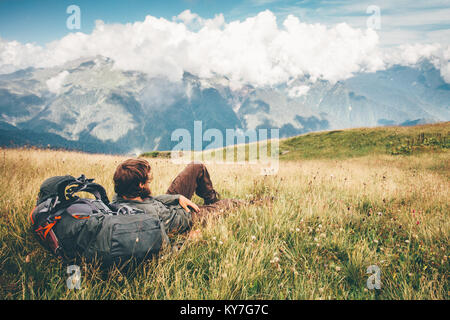 Man Traveler relaxing laying enjoying mountains landscape Travel Lifestyle hiking concept adventure summer vacations outdoor Stock Photo