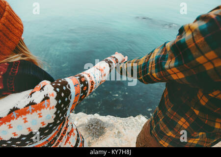 Couple in love holding hands Man and Woman Travel Lifestyle concept. Young family traveling romantic vacations autumn winter season Stock Photo