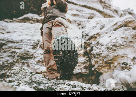 Traveler climbing at rocky mountains Travel Lifestyle wanderlust adventure concept summer vacations view under feet boots perspective Stock Photo
