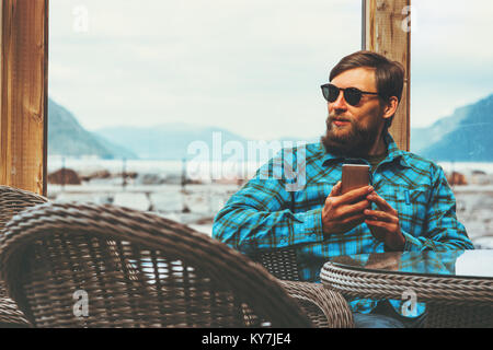 Handsome Man using smartphone Lifestyle success modern technology concept businessman sitting near window Stock Photo