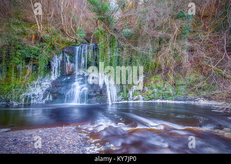 This waterfall sits in a gorge in Calderwood Country Park, between East and Mid Calder, West Lothian.The river in the foreground is the Linhouse Water Stock Photo