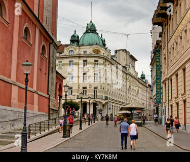 Tourists in on a street with renaissance revival buildings in in Ljubliana, Slovenia Stock Photo