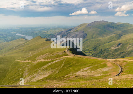 Walking down from Mount Snowdon on the Llanberis Path, Snowdonia, Gwynedd, Wales, UK - looking north towards the Clogwyn station, Llyn Padarn and Llan Stock Photo