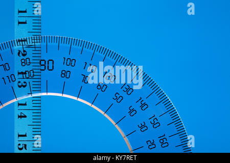 Transparent plastic protractor and ruler on blue background with copy space Stock Photo