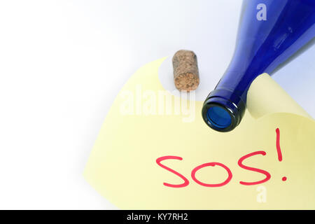 Yellow paper with red word SOS near open blue bottle on white background with copy space Stock Photo