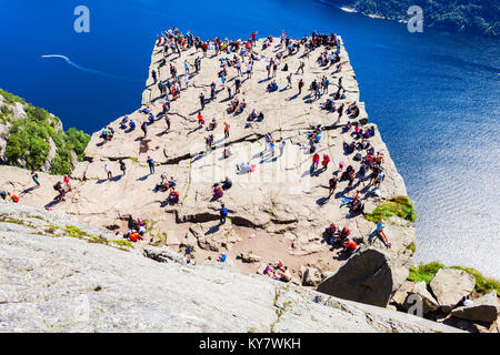 PREIKESTOLEN, NORWAY - JULY 23, 2017: Tourists at Preikestolen or Prekestolen or Pulpit Rock, famous tourist attraction near Stavanger, Norway. Preike Stock Photo