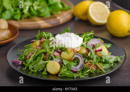 Potato lettuce salad with poached egg and onion Stock Photo