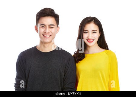 studio portrait of a young asian couple happy and smiling looking at camera, isolated on white background. Stock Photo