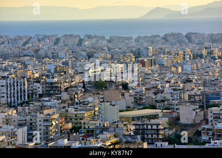 Near sunset view over city of Athens looking toward sea from Filopappou Hill (Hill of the Muses) Stock Photo