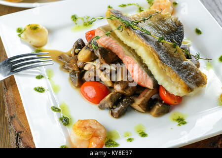 Roasted salmon with mushrooms and vegetables Stock Photo