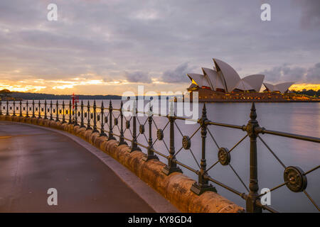 Image of the Sydney Opera House in Sydney, NSW, Australia from the boardwalk in front of Park Hyatt Sydney near Campbell's Cove Jetty at sunrise. Stock Photo
