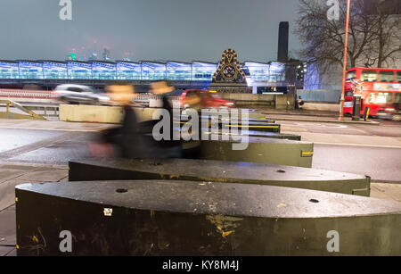 London, England, UK - January 11, 2018: Pedestrians walk through security barriers on Blackfriars Bridge in central London, recently installed in resp Stock Photo