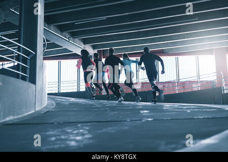 Back view of team practising together in parking place. Copyspace Stock Photo