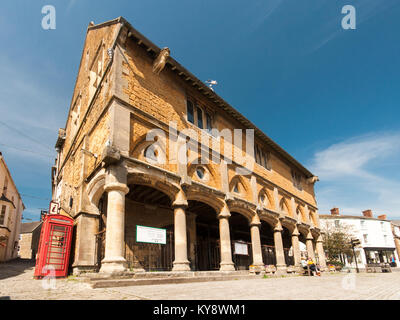 Castle Cary, England, UK - April 19, 2011: Sun shines on the distinctive Somerset stone of the traditional Market Hall in Castle Cary. Stock Photo