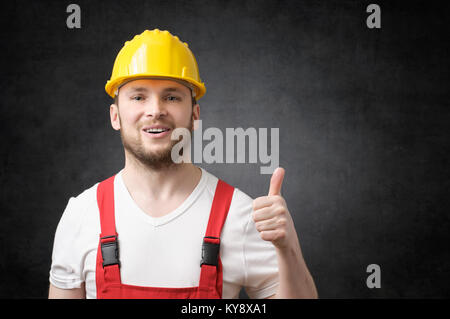 Happy worker showing thumbs up sign Stock Photo