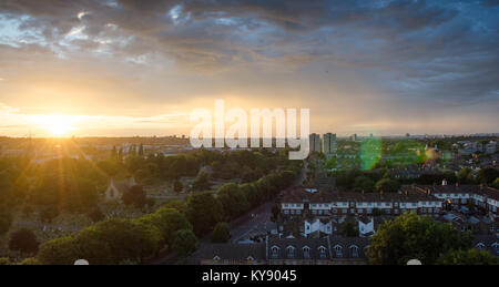 Sunset under stormy skies in Tooting, south west London, with Blackshaw Road and Lambeth Cemetery leading into a cityscape seen from the 13th floor of Stock Photo