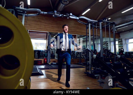 Businessman doing exercises in the gym. Stock Photo