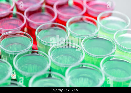 row line of different colored alcoholic cocktails on a party. wedding day or birthday Stock Photo