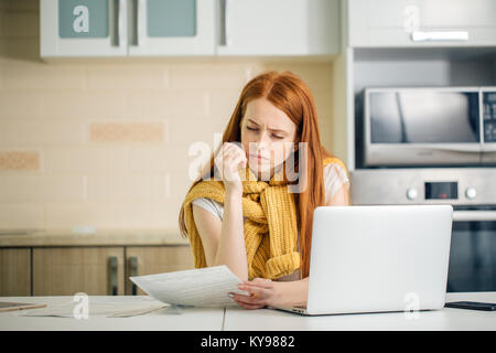 woman looking at screen of laptop with serious and concentrated expression Stock Photo