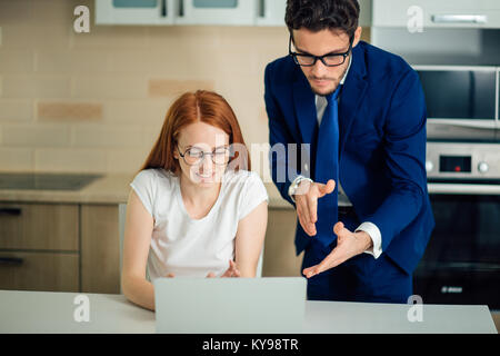 Two analysts discussing online data in front of laptop Stock Photo