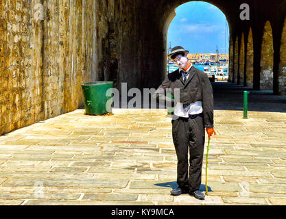 Heraklion, Greece - July 19, 2013: An actor in makeup clown posing near the port city of Heraklion on the island of Crete Greece. Stock Photo