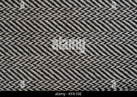 Herringbone (Broken Twill Weave) - a distinctive V-shaped weaving pattern. Closeup. Grey textured background. Stock Photo