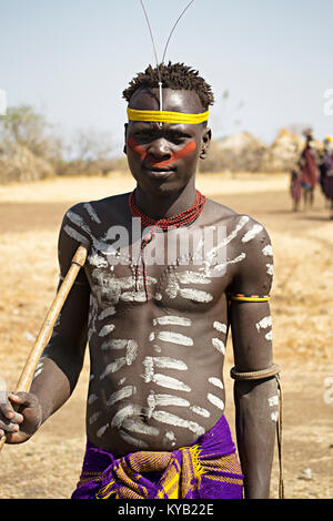 Mursi warrior shows scarification and body painting in lower Omo valley - Ethiopia. © Antonio Ciufo Stock Photo
