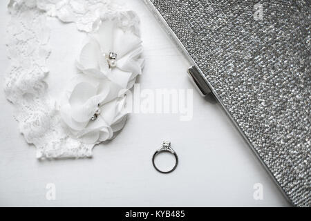 Wedding ring with garter on white background. Stock Photo