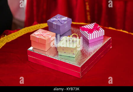 Image of wedding rings in a gift box on plastic flower tray, Select focus and blurred background Stock Photo