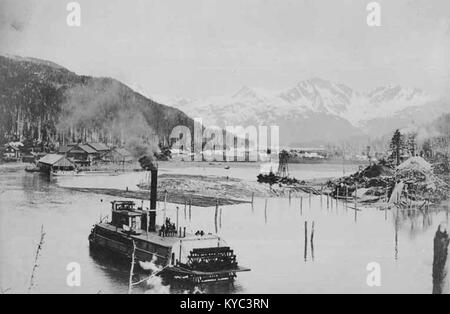 Odiak Slough showing steamboat, floating logs and construction activities of the Copper River and Northwestern Railway Company (HEGG 742) Stock Photo