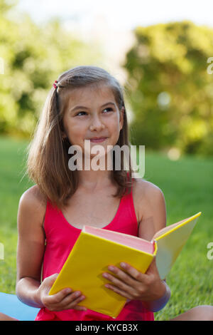Little girl hold yellow book Stock Photo