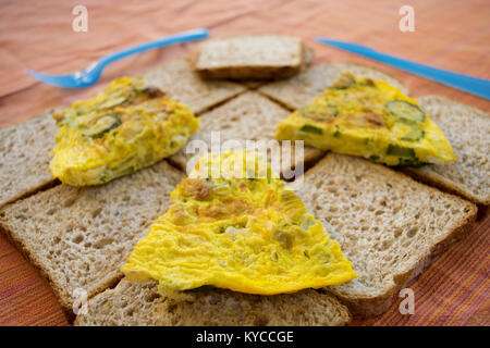 sliced wholemeal sandwich bread and zucchini omelete for a fast meal Stock Photo