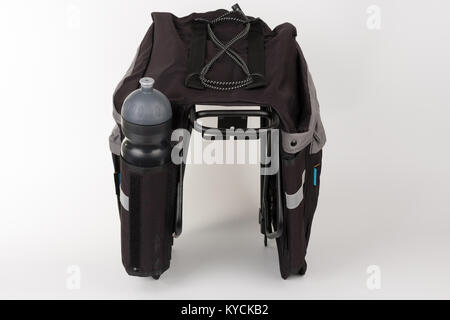 Bike carrier bag on rear rack , in pocket is water bottle, studio photo, isolated on white background Stock Photo