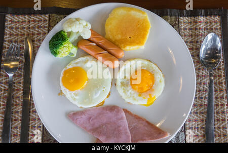 American breakfast with sunny side up eggs, bacon, toast, pancakes Stock Photo