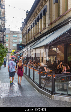 Couple holding hands walking on downtown street in Victoria Canada Stock Photo
